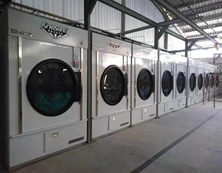 Which parts of a fully automatic industrial washer-extractor are most prone to damage